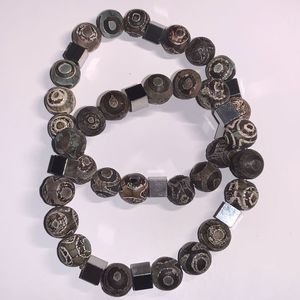 Pair of Tibetan dzi stretch bracelets with stainless steel accent beads